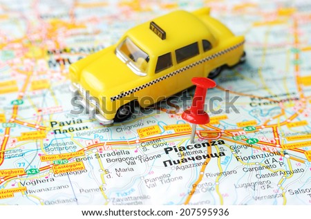 Close up of  Piacenca  , Italy map with red pin  and a taxi  - Travel concept