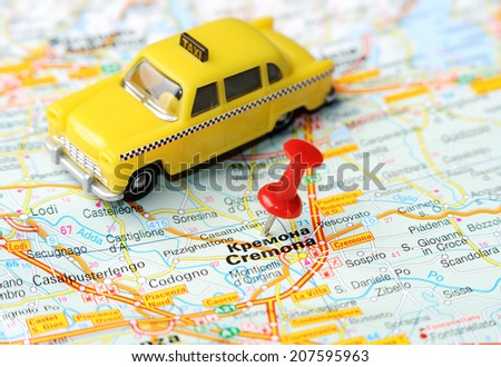 Close up of  Kremona  , Italy map with red pin and a taxi   - Travel concept
