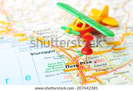 Close up of  Pisa  , Italy map with red pin and airplane    - Travel concept