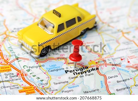 Close up of  Perugia  , Italy map with red pin and a taxi    - Travel concept