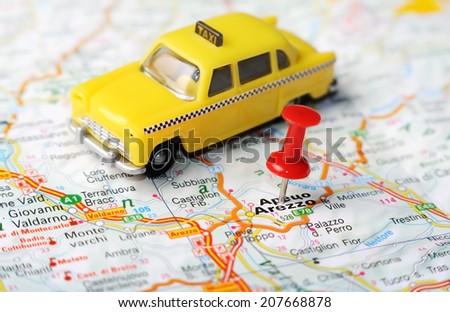 Close up of  Arezzo , Italy map with red pin and a taxi    - Travel concept