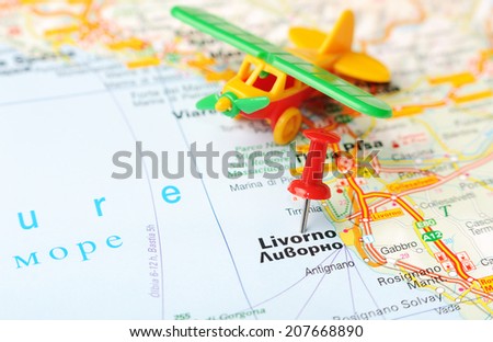 Close up of  Livorno  , Italy map with red pin and airplane   - Travel concept