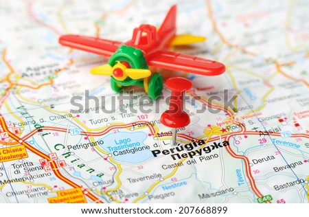 Close up of  Perugia  , Italy map with red pin and airplane   - Travel concept