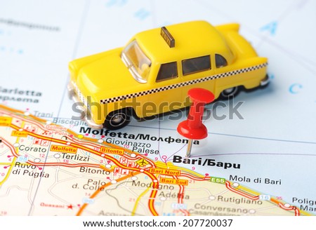 Close up of Bari  , Italy map with red pin and a taxi    - Travel concept