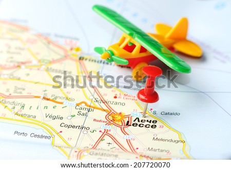 Close up of  Lecce , Italy map with red pin and airplane   - Travel concept