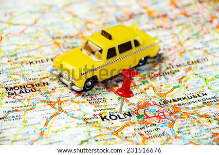Red push pin pointing at Coln,Germany  map   and a taxi