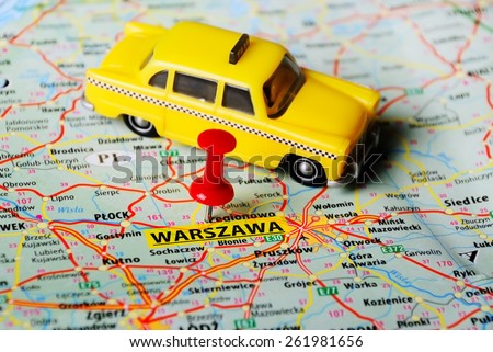 Close up of   Warsaw  , Poland  map with red pin and taxi toy
