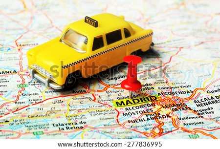 Close up of Madrid  ,Spain map , red pin and taxi toy  - Travel concept