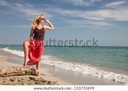 sexy girl in a red skirt relax by the sea