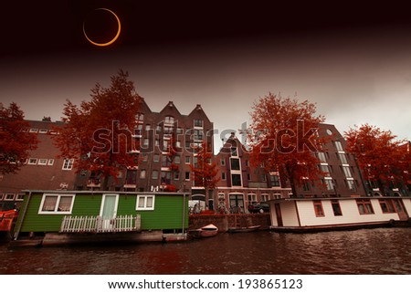 Solar Eclipse over the city Amsterdam. Elements of this image furnished by NASA