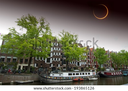 Solar Eclipse over the city Amsterdam. Elements of this image furnished by NASA