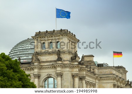 BERLIN, GERMANY - May 25, 2014: The Reichstag building and vacationers residents and visitors on the field. The Reichstag building is a historical edifice in Berlin.