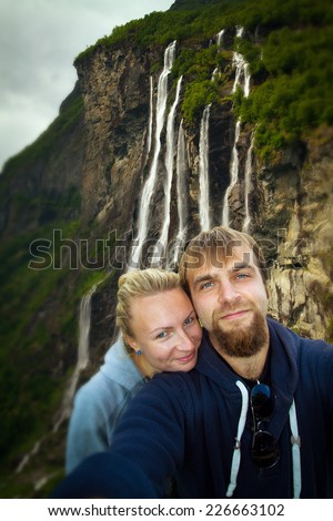 waterfalls northern Norwegian fjords. Honeymoon couple relaxing in Europe, a man and a woman.