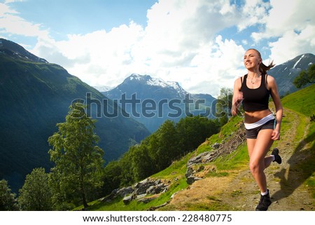 girl on a morning jog in the summer outdoors. Geiranger autumn. scenic landscapes of the northern Norwegian fjords.