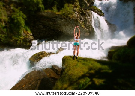 girl on a morning jog in the summer outdoors . mountain river. high in the mountains the river flows
