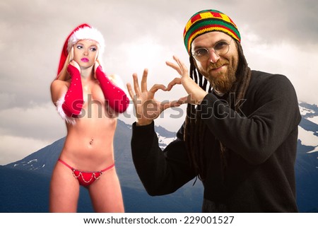 Rastafarian man celebrates Christmas at the North Pole with Santa Claus woman.