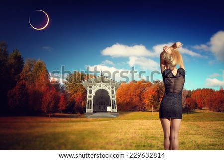 girl in autumn park. woman in a dress enjoying the fall