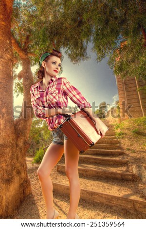 pin-up girl with a suitcase goes on vacation. Pin up vintage retro lifestyle