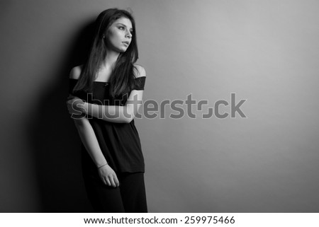black and white photo. Beautiful caucasian brunette woman with long shiny brown hair and clean skin. Portrait of a fashion model in studio