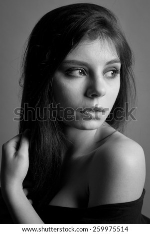 black and white photo. Beautiful caucasian brunette woman with long shiny brown hair and clean skin. Portrait of a fashion model in studio