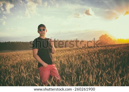 vintage retro style. lifestyle. a man in a field at sunset enjoying life, good weather, fresh air and silence