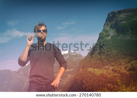 girl with the electronic cigarette in the mountains near the lake. instagram photo  e-cigarette. Photo instagram style. vintage retro.