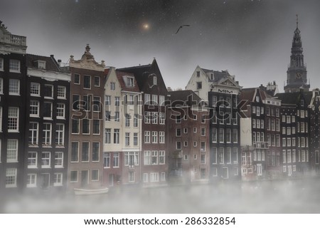 fog in Amsterdam at night by the light of stars. homes are near the river. mystical weather
