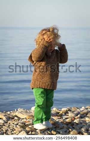 Girl in the autumn at the sea . standing against the evening sea
