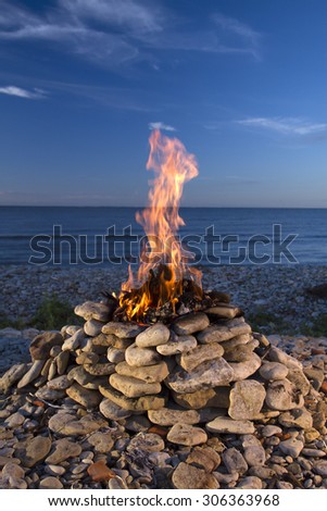fire burning on the sea in summer. Fire and Water