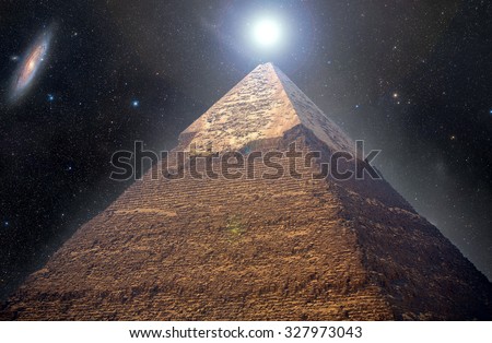 Pyramids of Giza in the background of the starry night sky. Elements of this image furnished by NASA