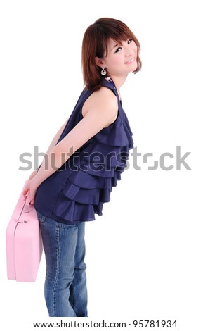 Young woman in blue jeans carrying a pink metal case.