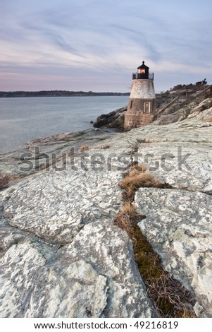 Castle Hill Lighthouse at sunset using the crack in rocks as a lead in line