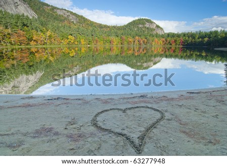 a heart in the sand with  the mood of i love fall