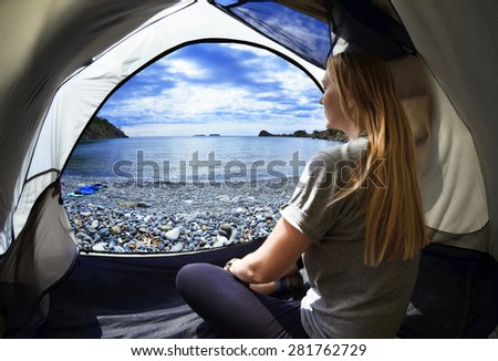 Happy woman sitting in a tent ,view of mountains ,sky and sea in Turkey