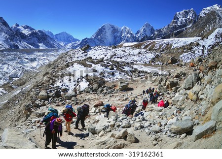 Trekking in Himalaya. Group of hikers  with backpacks   on the trek in Himalayas, trip  to the base camp Everest