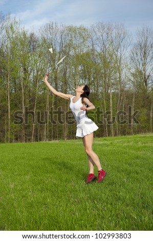 Woman playing badminton game in the park