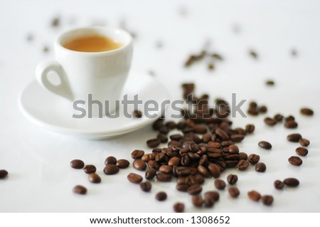 coffee cup and coffee beans (focus on beans)
