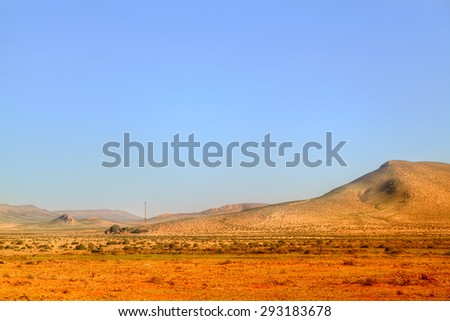 picturesque landscape in the desert of Morocco in the near of Tan Tan in West Sahara with sand dunes in the background