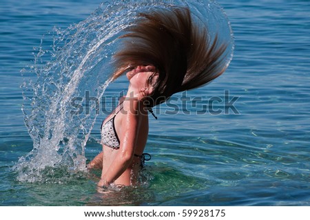 Girl is splashing water with her hair