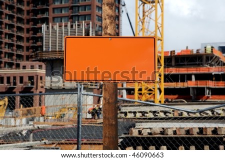blank construction sign against construction site