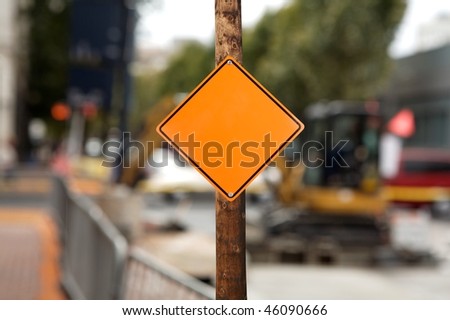 blank construction sign against construction site