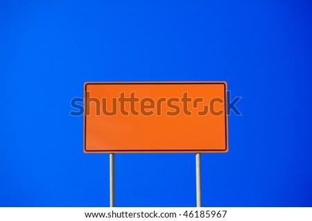 Blank construction sign against clear blue sky