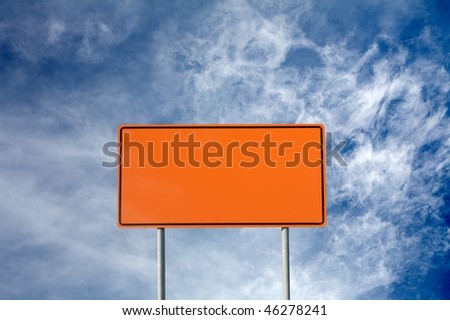 Blank orange construction sign against cloudy sky