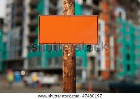 Blank construction sign on a electric wooden pole construction site on background