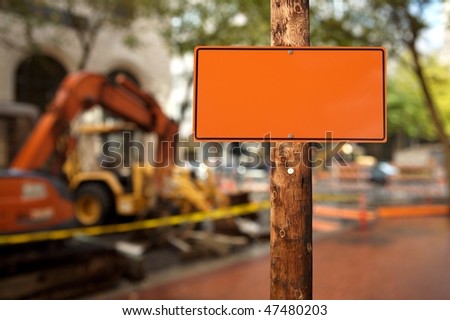 Blank construction sign on a electric wooden pole construction site on background