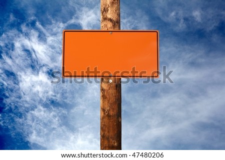 Blank construction sign on a electric wooden pole cloudy sky on background
