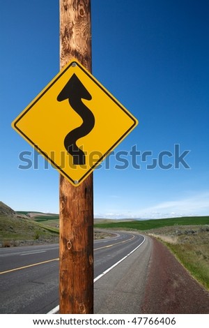 Winding traffic sign winding road on background