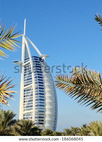Dubai, United Arab Emirates - December 28, 2013 : View of Burj Al Arab hotel from the Jumeirah beach. It is one of the Dubai landmark, and one of the world\'s most luxurious hotels with 7 stars.
