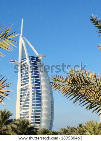 Dubai, United Arab Emirates - December 29, 2013 : View of Burj Al Arab hotel from the Jumeirah beach. Burj Al Arab is one of the Dubai landmark, and one of the world\'s most luxurious hotels.