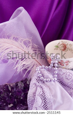 Amethyst stone, lavender pearls and old china cup with overall lavender color.